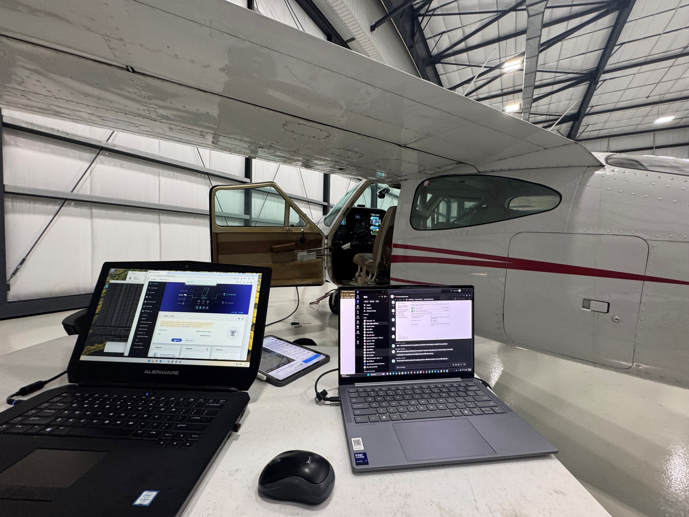Laptop computers connected to an aircraft during avionics systems testing in a hangar