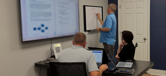 Rivercode software engineers collaborating at a whiteboard in Satellite Beach